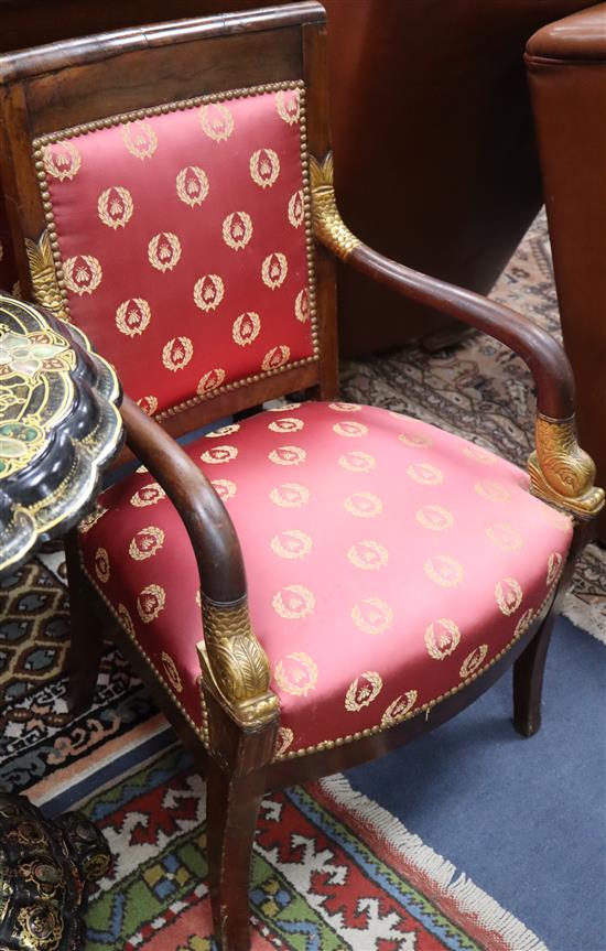 A pair of Empire style parcel gilt upholstered elbow chairs